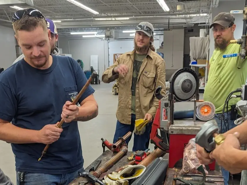 Three men using tools