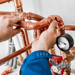 Person doing pipefitting work