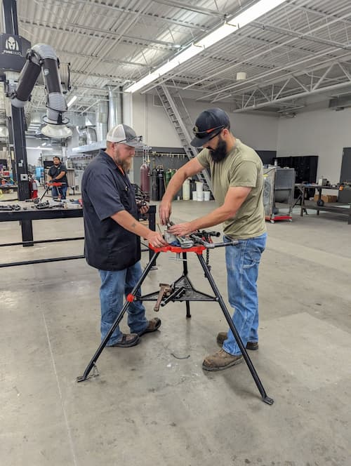 Two people using equipment